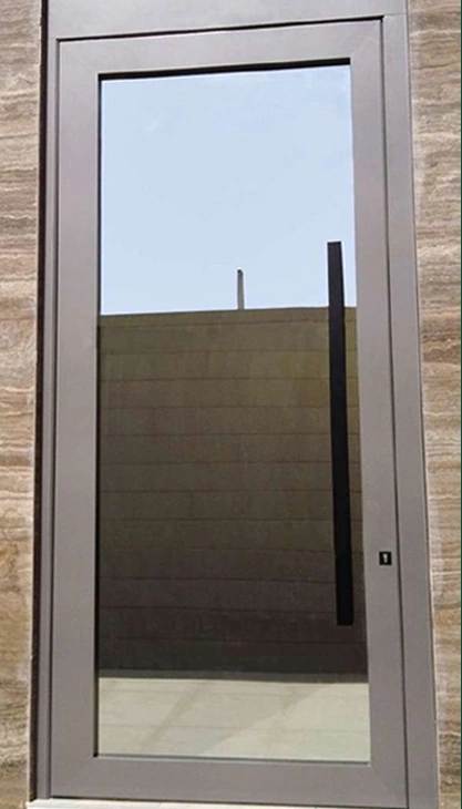 A framed glass door with a tall pull handle and dark surrounding frame.